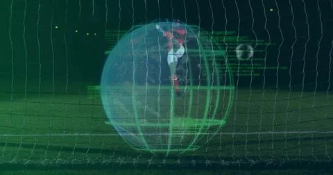 Leaping goalkeeper in red kit diving toward soccer ball in stadium net, with Stock-Fotos