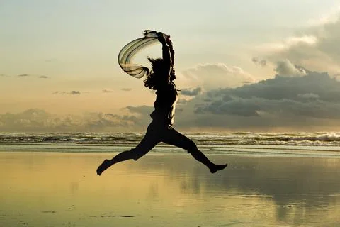 Leaping at sunset. Stock Photos