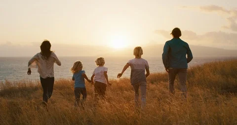 Leaping into the sunset together Stock Footage 102872860