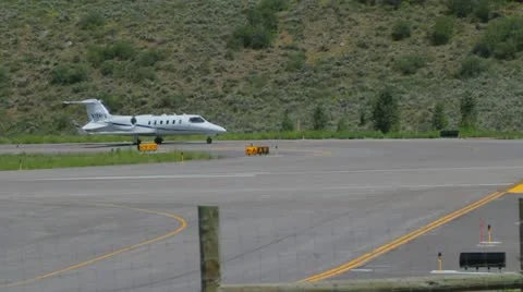 Learjet 31A taxis down runway to takeoff point and flies away - series - 4 Video stock 11981145