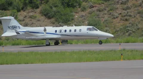 Learjet 31A taxis down runway to takeoff point and flies away - series - 2 Video stock 11981150