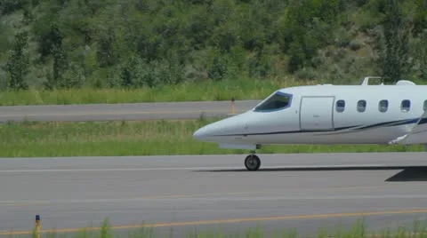 Learjet 31A taxis down runway to takeoff point and flies away - series - 5 Video stock 11981258