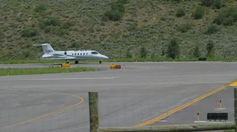 Learjet 31A taxis down runway to takeoff point and flies away - series - 3 Video stock 11981274