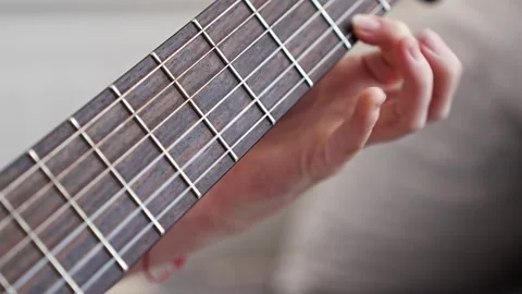 Learn basic guitar chords to play simple songs at home 스톡 동영상 332469676