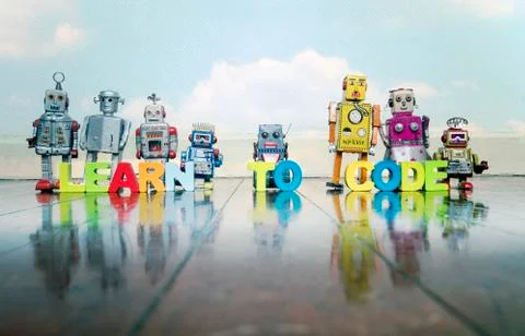 LEARN TO CODE wooden letters and retro robot toys Stockfoto's