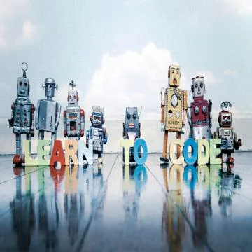 LEARN TO CODE wooden letters and retro robot toys Stock Photos