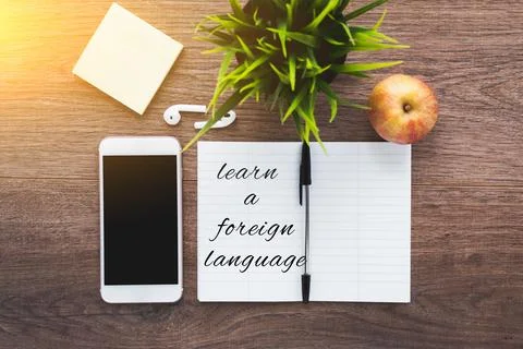 Learn foreign language notebook, smartphone, wireless headphones, pen on a .. Stock Photos