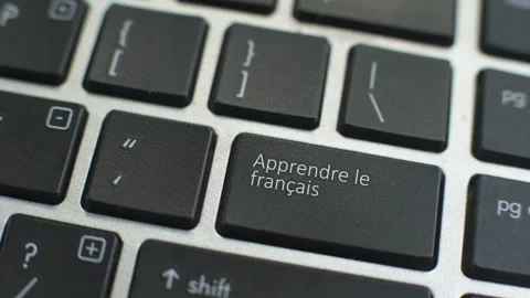Learn French button on computer keyboard, female hand fingers press key Stock Footage 97828824