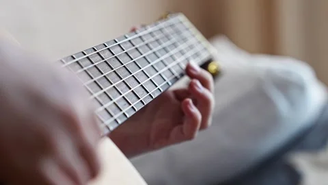 Learn guitar chords at home with simple step-by-step guide 스톡 동영상 332467960
