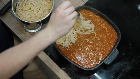 Learn how to cook Spaghetti topped with a Rich Tomato Sauce Stock Footage 314024090