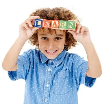 Learn with an open mind. Studio shot of a cute little boy holding building Fotos de archivo