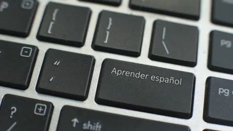 Learn Spanish button on computer keyboard, female hand fingers press key Stock Footage 97826864