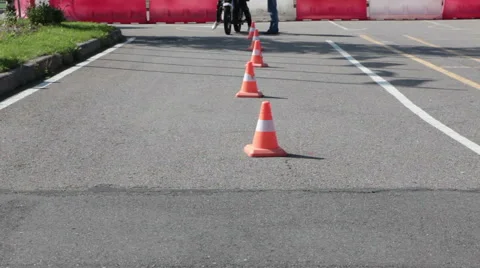 Learner motorcyclist does wave driving with cones on skill training in motordrom Stock Footage 66518154