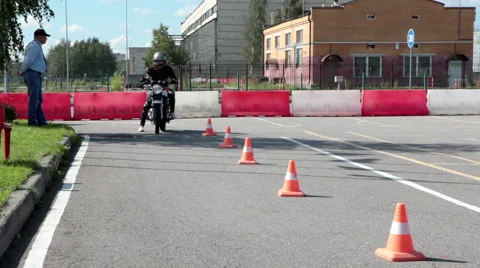 Learner motorcyclist tries to start driving on motorbike in motordrome Stock Footage 66518187