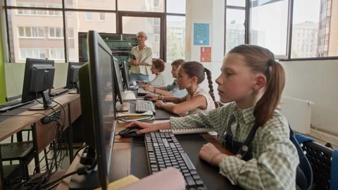 Learners Working with Computers and Raising Hands to Answer Teacher Question Stock Footage 316478171