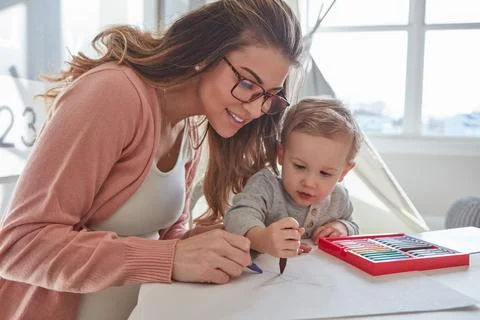 Learning about colours by making scribbles. a woman and her young son using Stock Photos