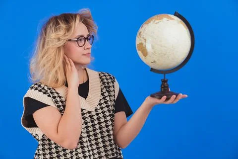 Learning about the globe. Geography concept. Young teenage girl in glasses Stock Photos