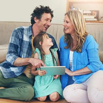 Learning about technology is a family experience. a happy family using a digital Stock Photos