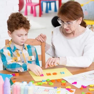 Learning alphabet with plastic letters Stock Photos