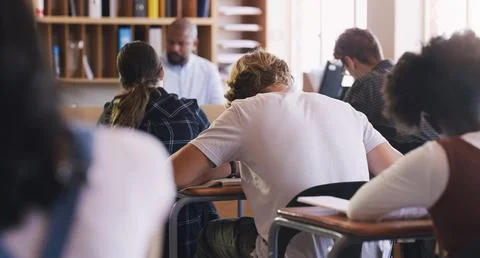 Learning to appreciate the value of hard work. teenagers writing an exam in a Stock Photos