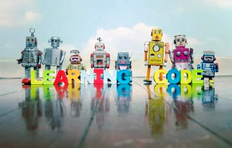 LEARNING CODE wooden letters and retro robot toys Foto stock