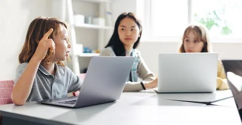 Learning to coding together: Kids engage with each other as they learn prog.. Stock Photos
