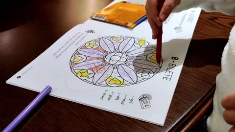 Learning to color doodle mandala art with crayons as a child Stock Footage 145982059