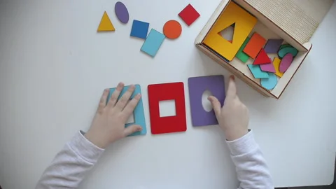 Learning colors and shapes. Children's wooden toy. The child collects a sorter Stock Footage 144840409