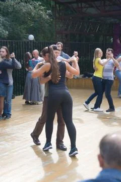 Learning to dance in the city park. Stock Photos