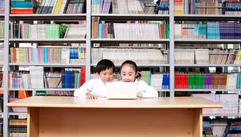 Learning Digital Two people. Children Curious Indoor Oriental figures Laptop Stock Photos