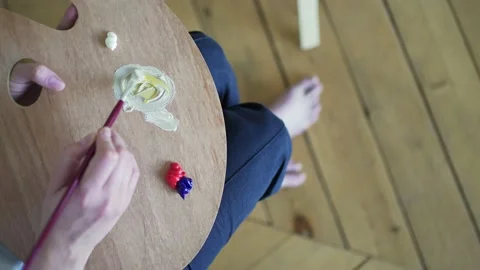 Learning to draw. The student mixes oil paints on the palette. Close-up Stock Footage 160105547