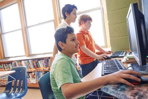 Learning, education and students on computer in classroom or middle school Foto stock