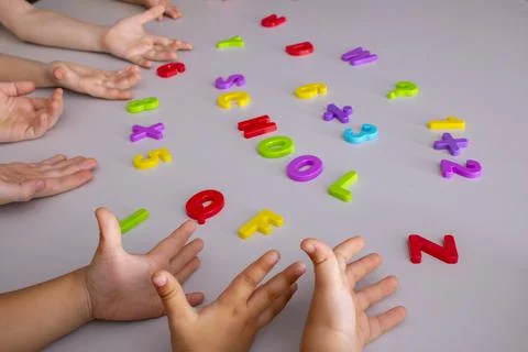 Learning elements. School supplies with kids hands 스톡 사진