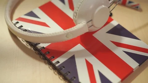 Learning english courses logo concept with british flag and headphones. English Stock Footage 85579641