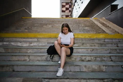Learning female student preparing for graduation outdoors in summer. Stock Photos