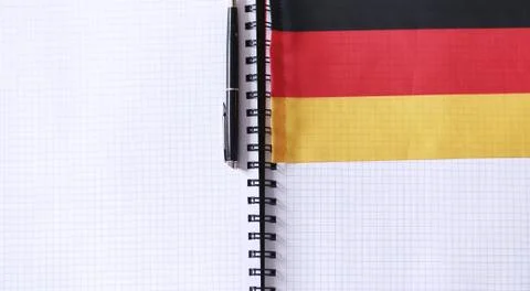 Learning foreign languages. Notepad for entries and a flag. Lang Stock Photos