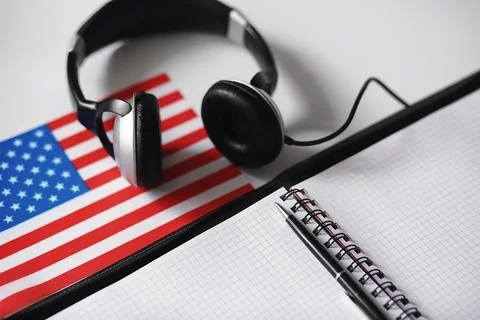 Learning foreign languages. Notepad for entries and a flag. Language course.. Stock Photos