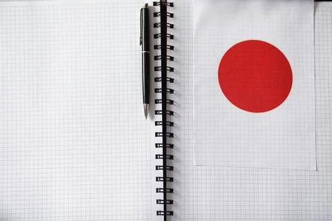 Learning foreign languages. Notepad for entries and a flag. Language course.. Stock Photos