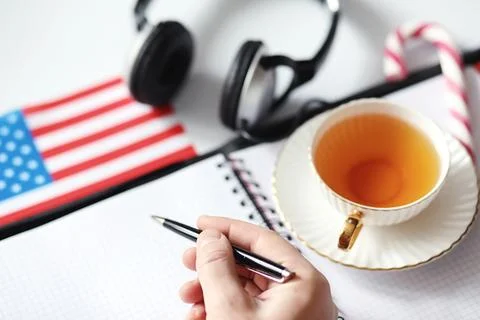 Learning foreign languages. Notepad for entries and a flag. Language course.. Stock Photos