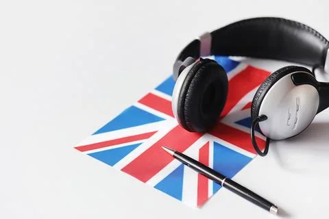 Learning foreign languages. Notepad for entries and a flag. Language course.. Stock Photos