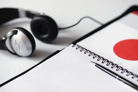 Learning foreign languages. Notepad for entries and a flag. Language course.. Stock Photos