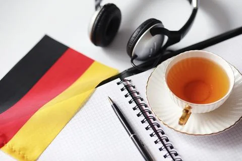 Learning foreign languages. Notepad for entries and a flag. Language course.. Stock Photos