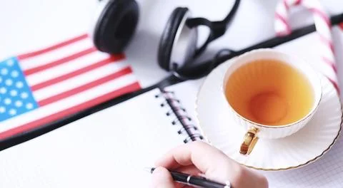 Learning foreign languages. Notepad for entries and a flag. Language course.. Stock Photos