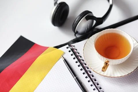 Learning foreign languages. Notepad for entries and a flag. Language course.. Stock Photos