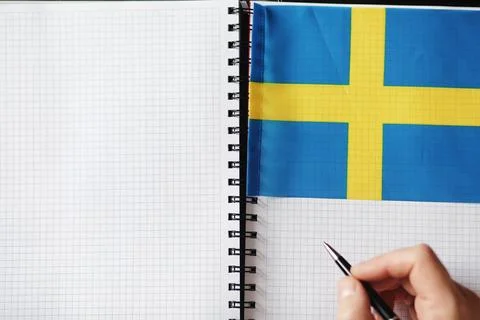 Learning foreign languages. Notepad for entries and a flag. Language course.. Stock Photos