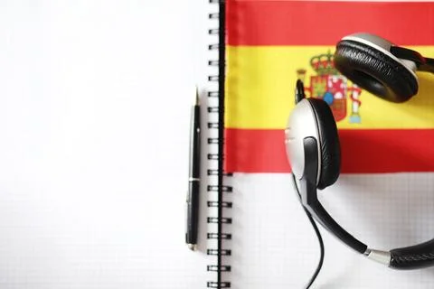 Learning foreign languages. Notepad for entries and a flag. Language course.. Stock Photos
