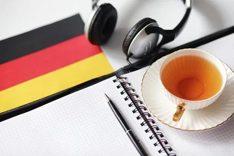 Learning foreign languages. Notepad for entries and a flag. Language course.. Stock Photos