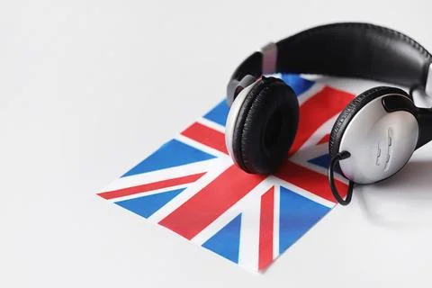 Learning foreign languages. Notepad for entries and a flag. Language course.. Stock Photos