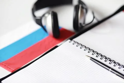 Learning foreign languages. Notepad for entries and a flag. Language course.. Stock Photos