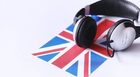 Learning foreign languages. Notepad for entries and a flag. Language course.. Stock Photos